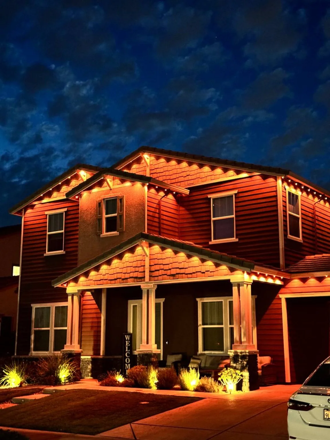 Warm amber holiday roofline lighting